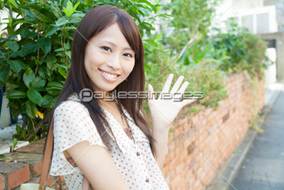 笑顔で手を振る女性 商用利用可能な写真素材 イラスト素材ならストックフォトの定額制ペイレスイメージズ