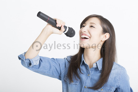 マイクを持って歌う女性 商用利用可能な写真素材 イラスト素材ならストックフォトの定額制ペイレスイメージズ
