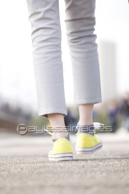 スニーカーで歩く女性の足元 商用利用可能な写真素材 イラスト素材ならストックフォトの定額制ペイレスイメージズ