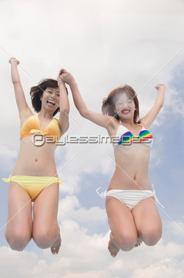 ジャンプする水着姿の女性2人