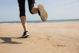 Fit woman jogging on the sand