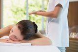 Beautiful woman lying on massage table at spa center