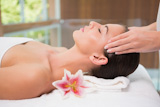 Attractive woman receiving head massage at spa center